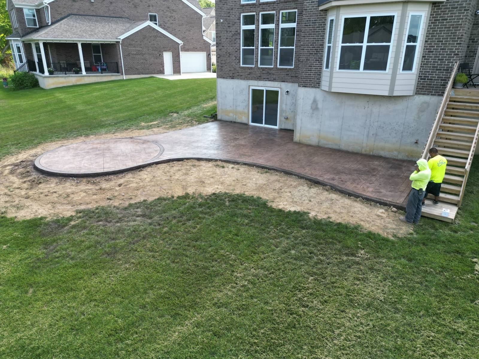 Aerial view of a curved concrete patio and driveway installed in Dayton, Ohio