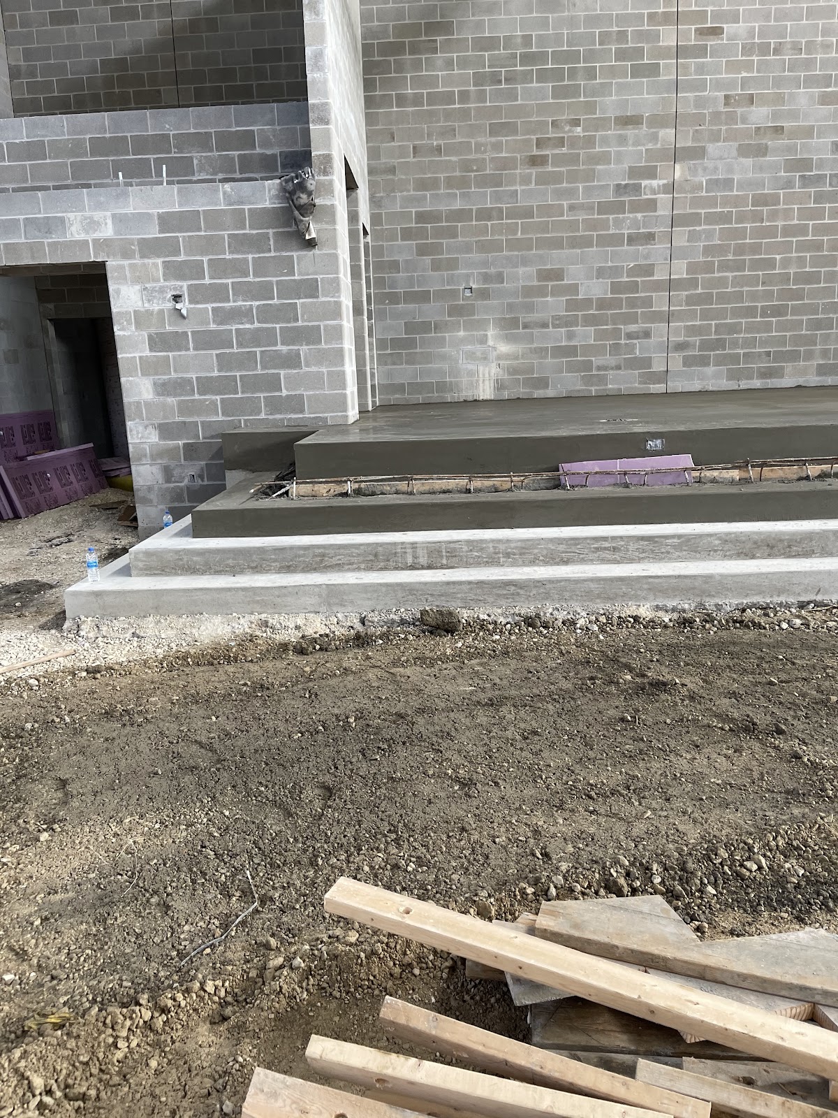 Freshly poured concrete entry steps and landing at a new commercial CMU building