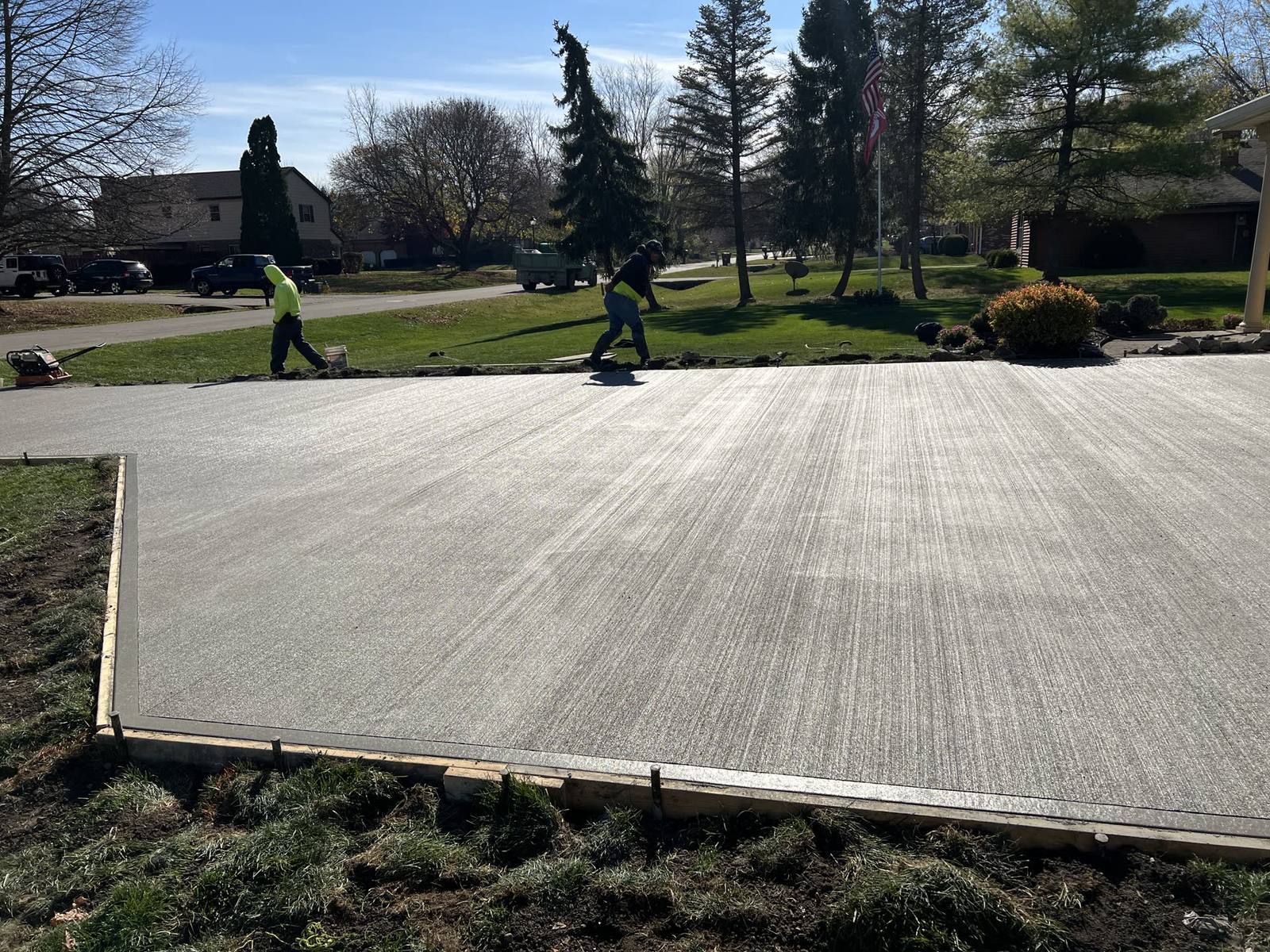 Warm-toned stamped concrete patio with a curved perimeter in a Dayton-area backyard