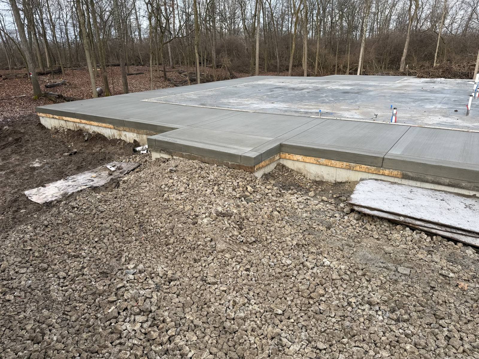 Light-gray stamped concrete pool patio with curved steps near Springfield, Ohio