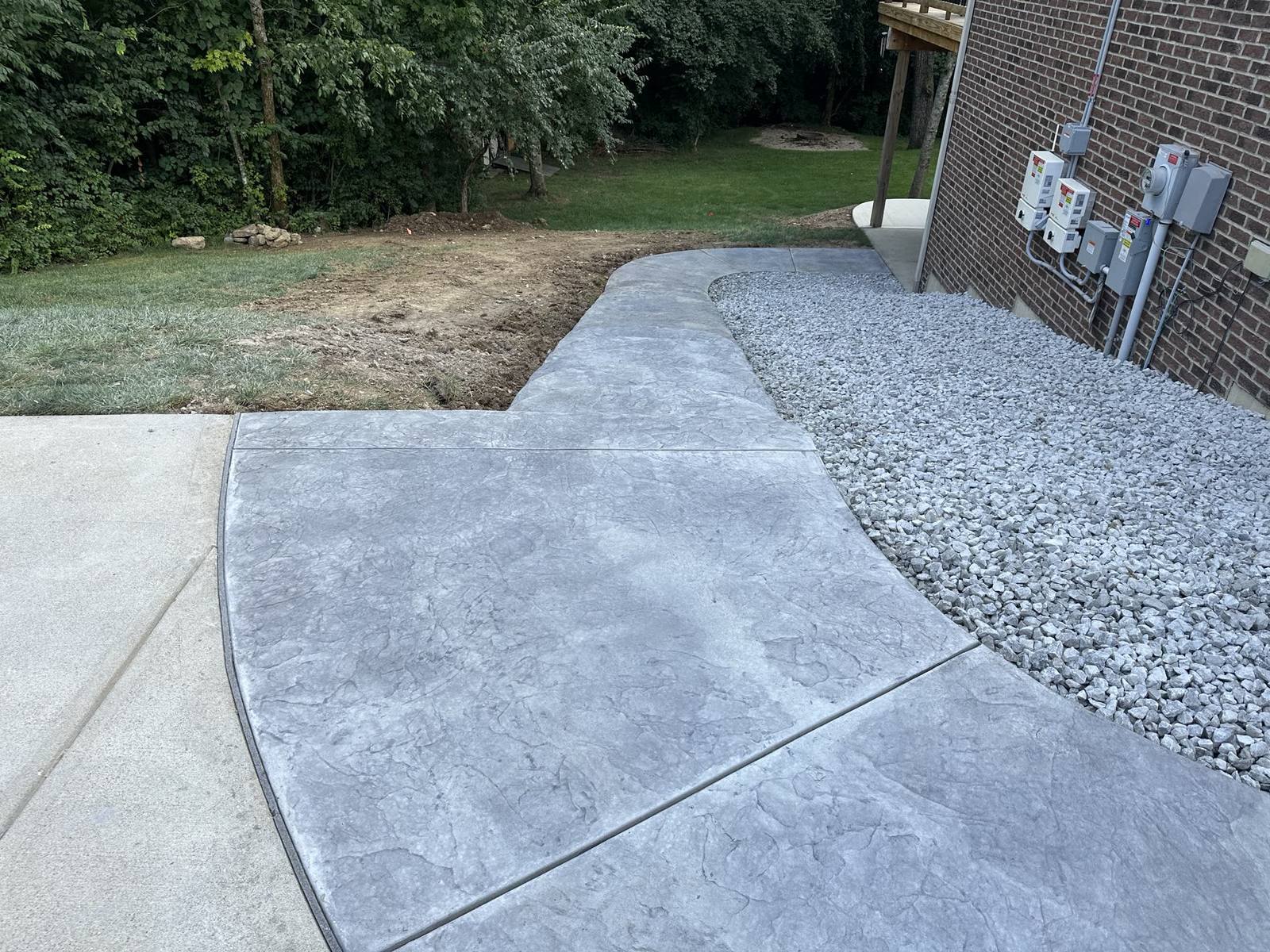 New rectangular concrete patio installed at a brick home in Dayton, Ohio