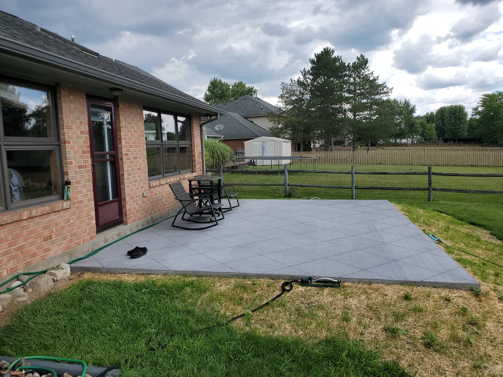 Wide outdoor concrete patio alongside a brick home in the Dayton metro area